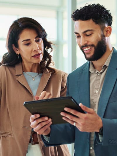 Coworkers discussing content federation on tablet in office setting
