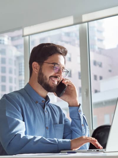Man in glasses taking a call