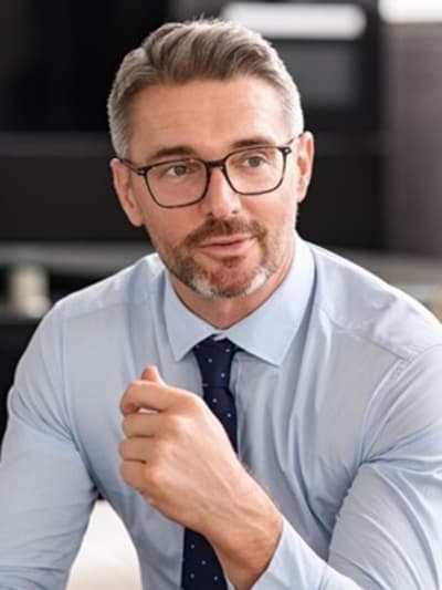 Man in business attire sitting in an office