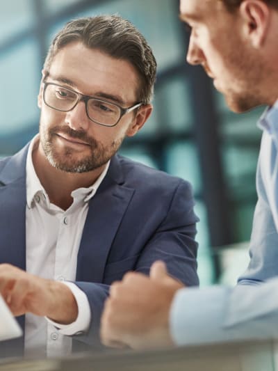 Man with tablet during meeting of business people in office discussion