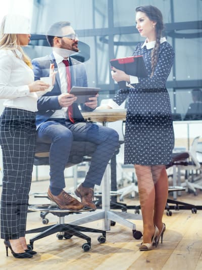 Three office coworkers having a discussion