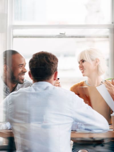 group of 4 people discussing in a meeting