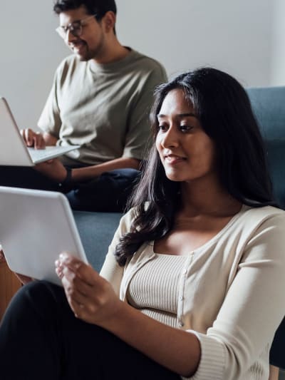 two people working on their laptop and tablet