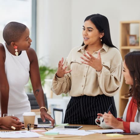 diverse female office coworkers have a discussion