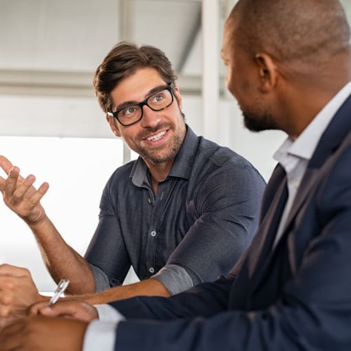 Two businessmen discussing information on a device