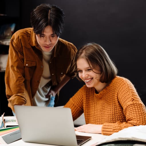 two people discussing and staring at the laptop screen