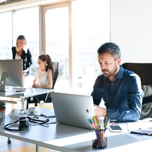 People working on cloud-based platforms in an office.