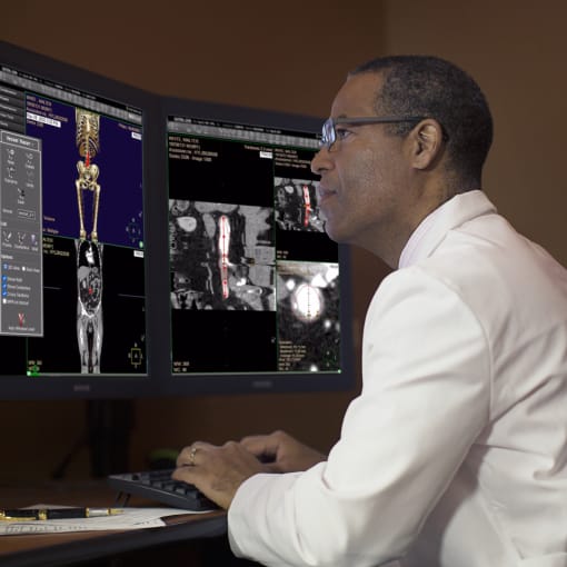 Doctor looking at enterprise medical imaging on a computer monitor