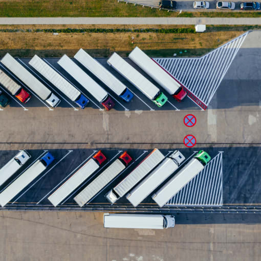 Transport trucks parked at a storage location.