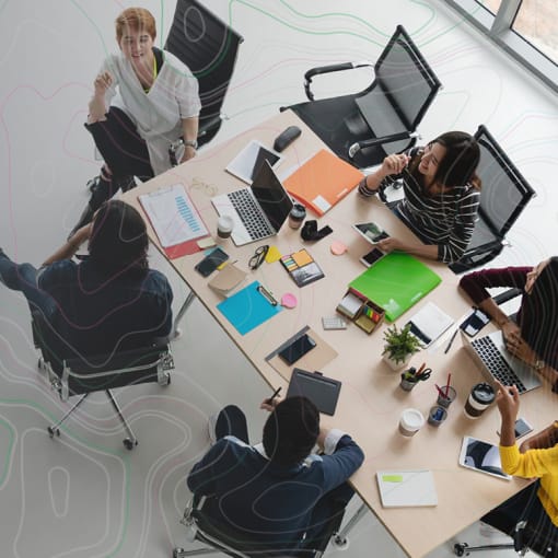 Overhead shot of people in an open office setting.