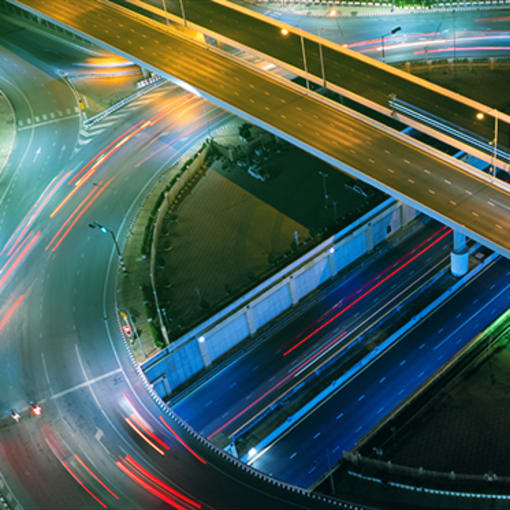 Long exposure of cars traveling on a highway system.