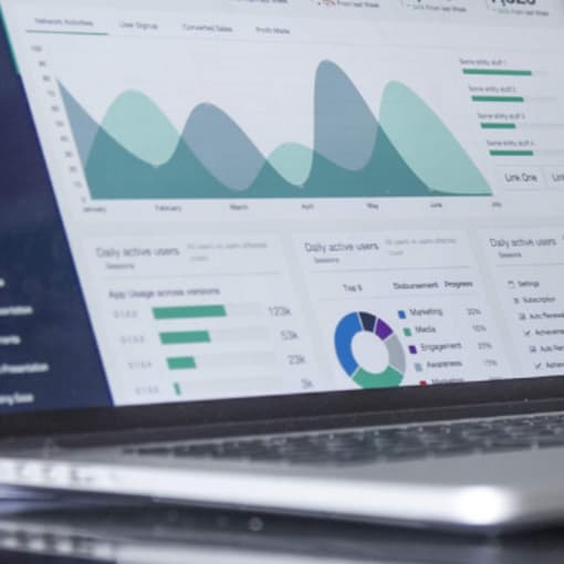 Business analytics dashboard on a laptop.