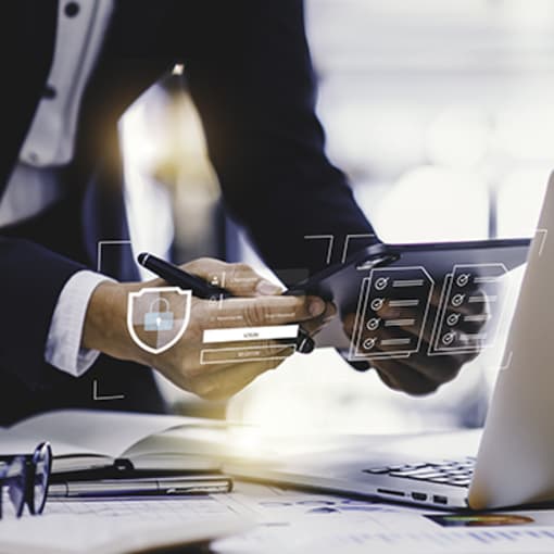 Person in suit works on a laptop.