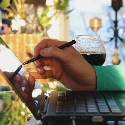 Person uses a stylus on a keyboard.