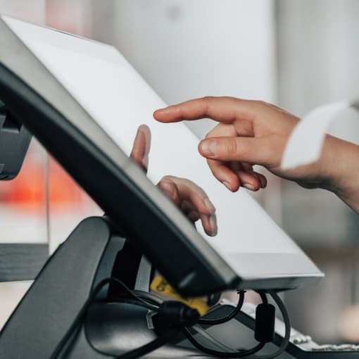 Retail worker uses a point-of-sales system.