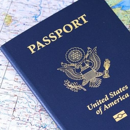 A U.S. passport sits on a map of the northern United States.