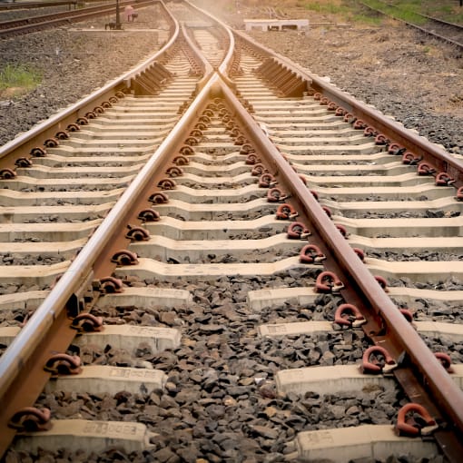 Two sets of train tracks converge.