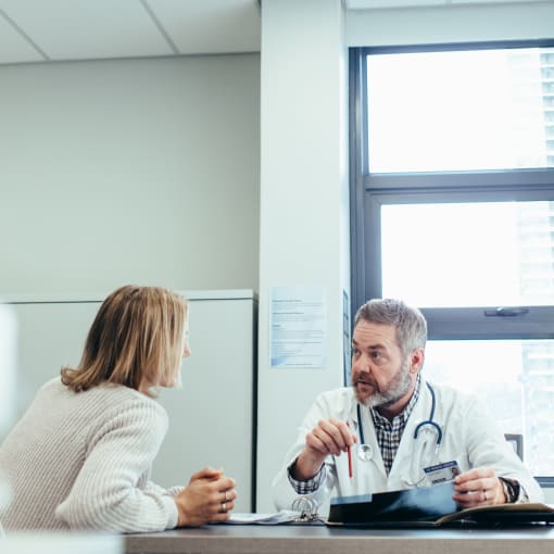 Doctor and staffer having a discussion in a hospital office