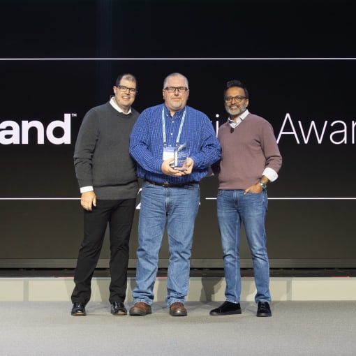 Hyland senior vice president and chief strategy officer Chris Winczewski (left) and president and CEO Jitesh Ghai (right) are joined by Matt Seagren from Erie Insurance, which won this year’s Digital Visionary of the Year Award at Hyland’s annual Innovation Awards.