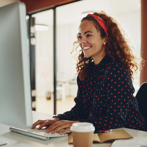 Young professional works at a desktop computer.