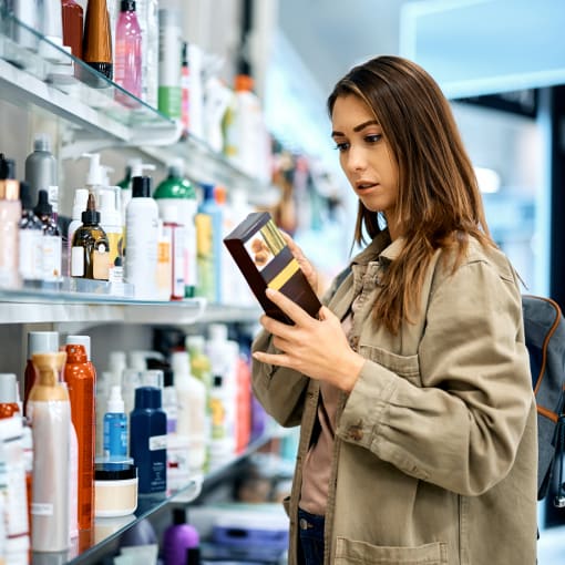 woman checking out beauty products in an aisle