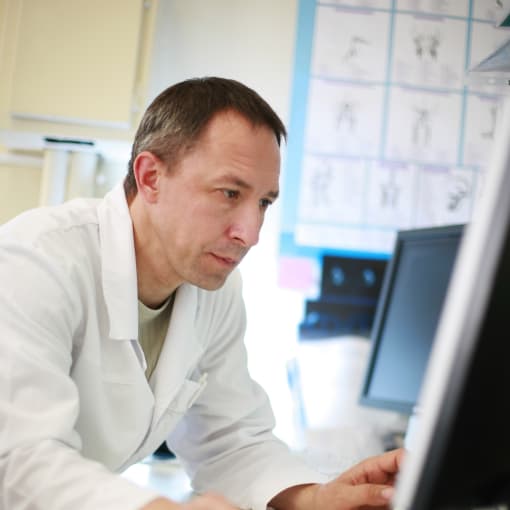 Hyland Healthcare customer uses a desktop computer in a hospital setting.