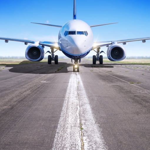 Airplane sits on the tarmac. 