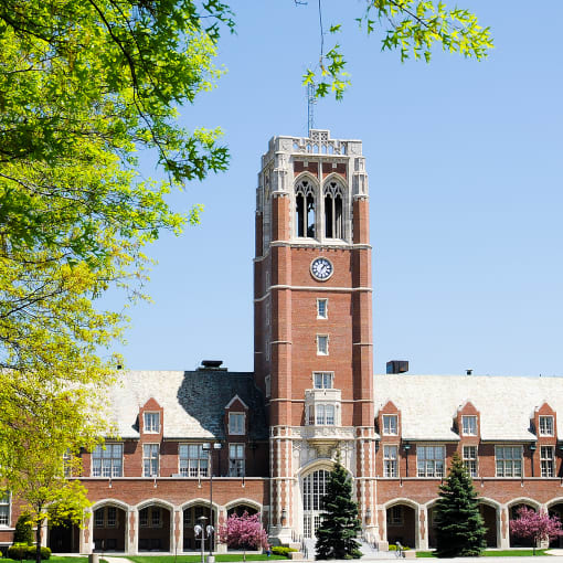 The exterior of John Carroll university, which has red brick and a tower.