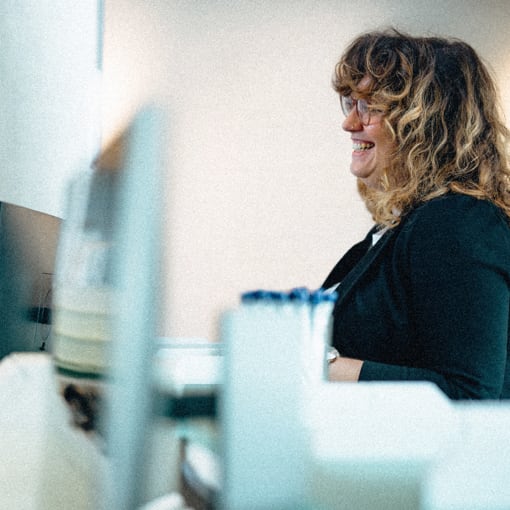 Office worker sitting in front of a desktop computer.