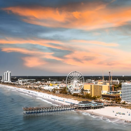 Aerial shot of Myrtle Beach showing a Ferris wheel and pier.