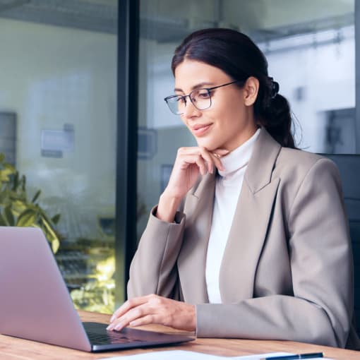 Businesswoman working on a laptop in an office setting