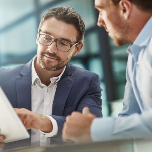 Man with tablet during meeting of business people in office discussion