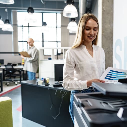 Female office worker using multifunction scanner