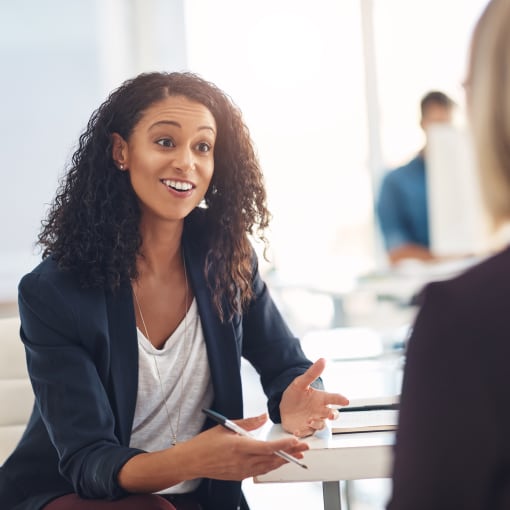 Female employees talking and smiling