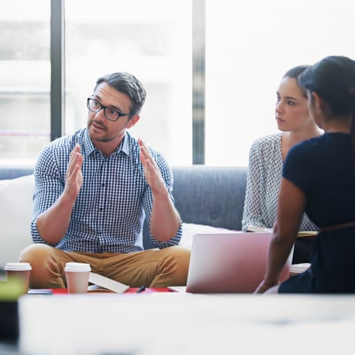 Office employees having seated discussion