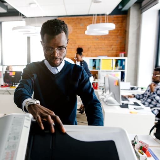 Male office worker using multifunction scanner