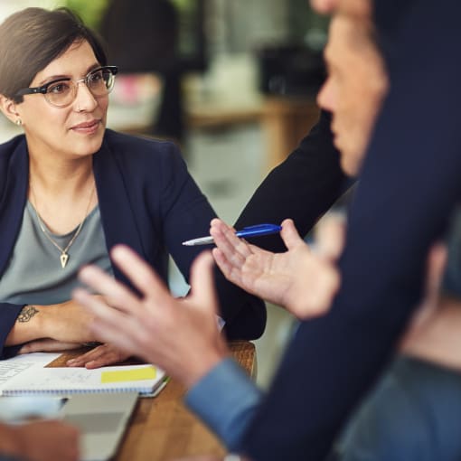 Female colleagues talking at a desk