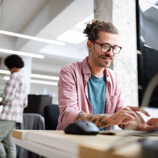 Male technology professional typing at desk