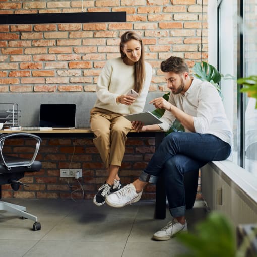 Two office colleagues looking at a tablet