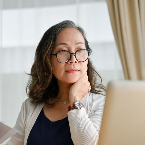 Business professional sits at a desk with a laptop computer.