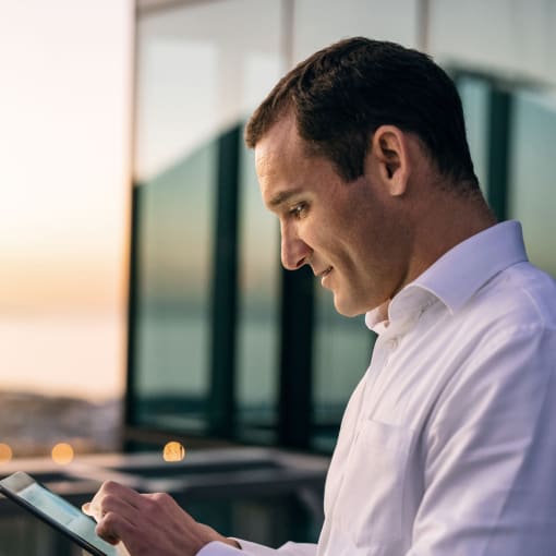 Person accesses an e-book on a tablet outdoors.