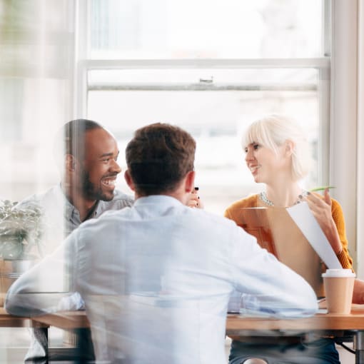 group of 4 people discussing in a meeting