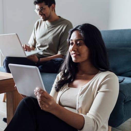 two people working on their laptop and tablet