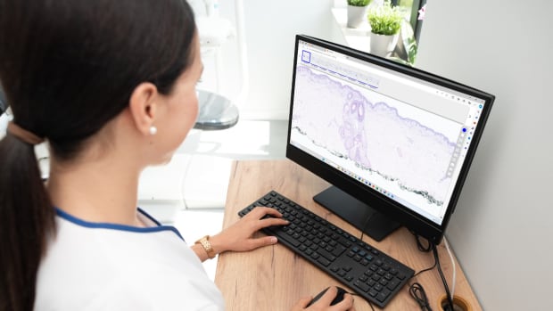 Pathologist sitting at a desktop computer