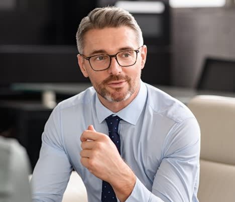 Man in business attire sitting in an office