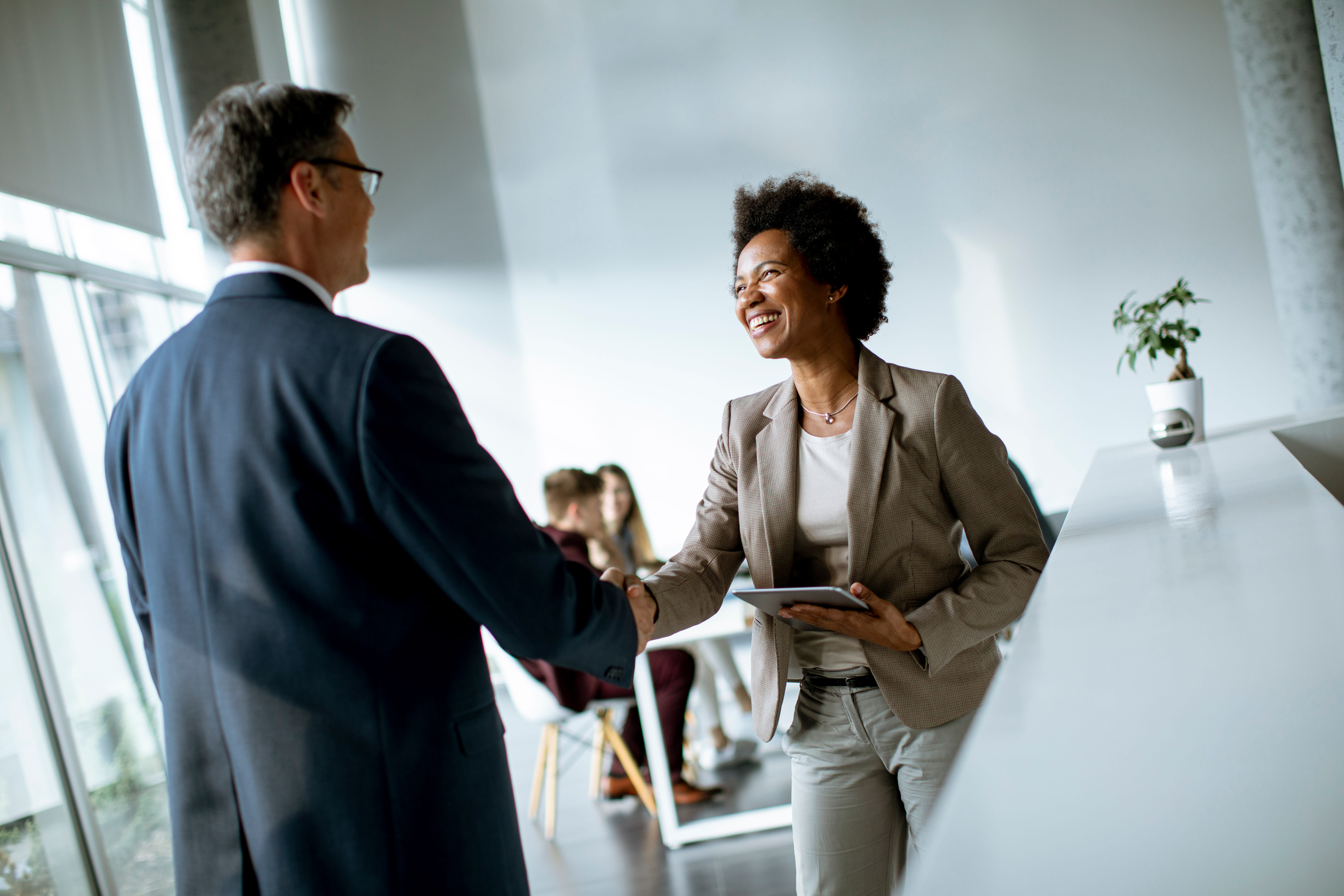 Two people begin a professional relationship and introduce themselves by shaking hands.