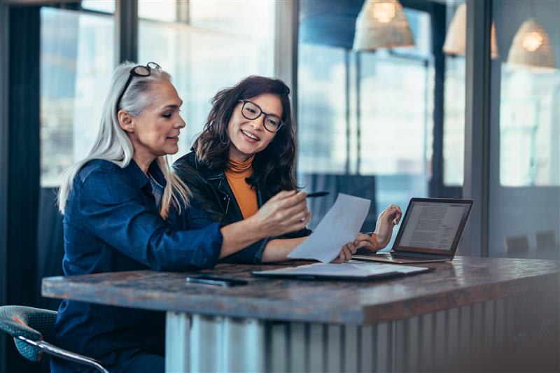 Two women in an office looking at a document