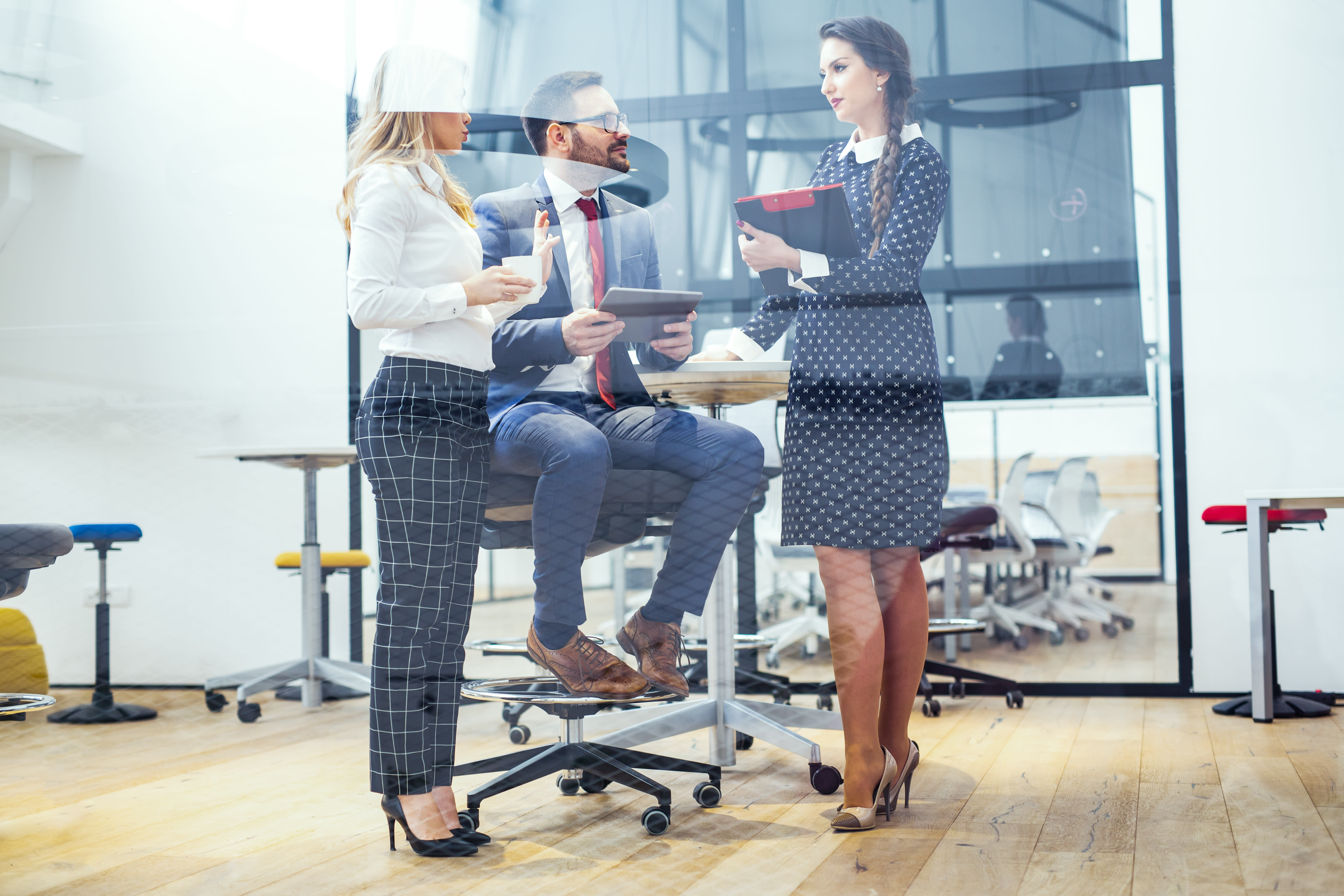 Three office coworkers having a discussion