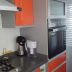 cocina naranja con cubierta cuarzo negro y gris galaxy