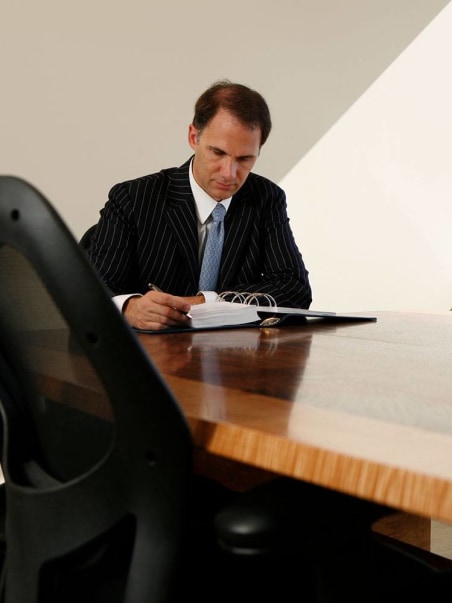 Dr. Aaron DeShaw at conference table